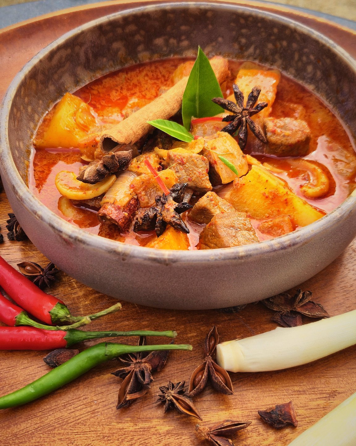 Massaman curry in a clay bowl ringed by cinnamon, star anise, chillies and lemongrass, RICE Bar + Restaurant, Patong