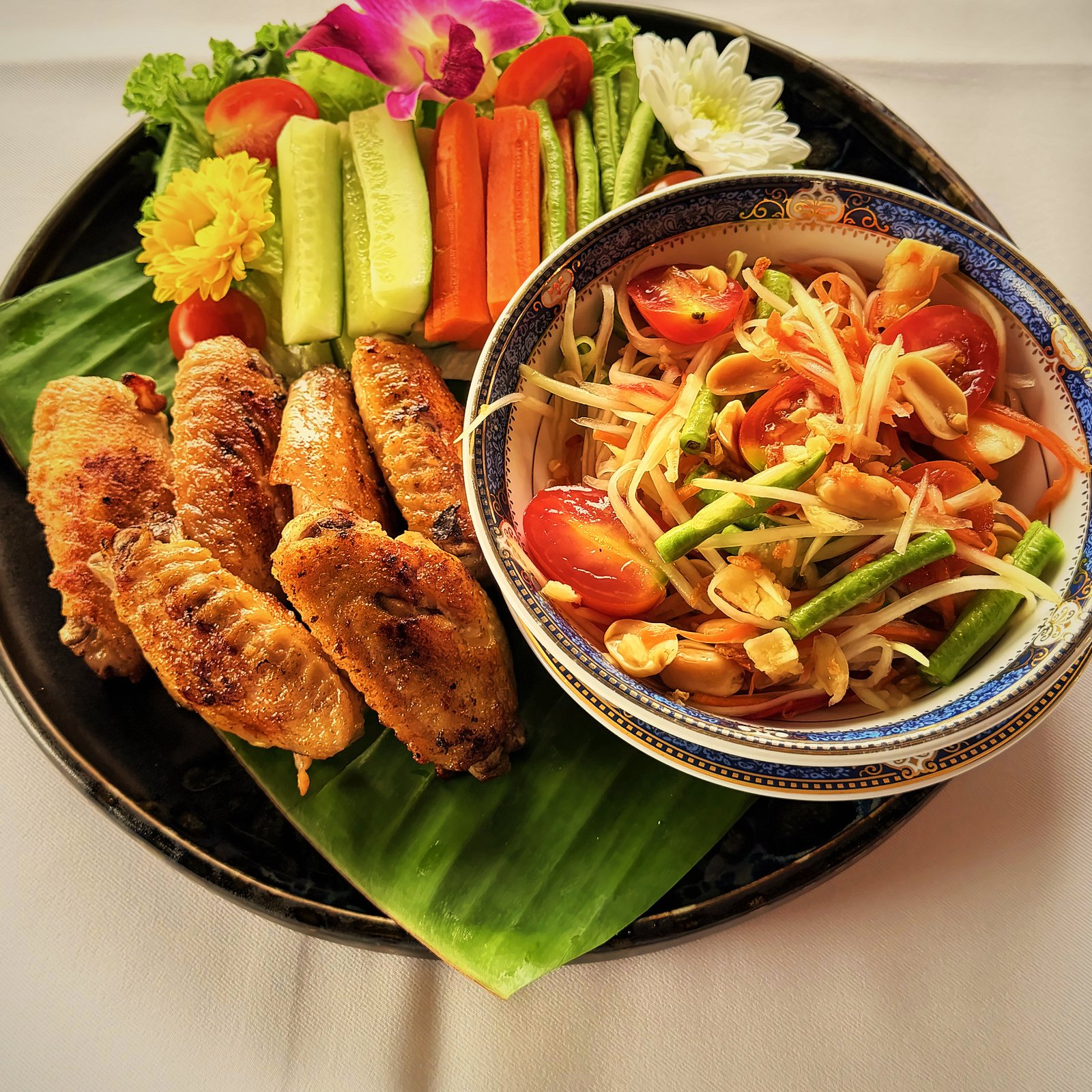 Som taam green papaya salad with gai yang grilled chicken on banana leaf, RICE Bar + Restaurant, Patong